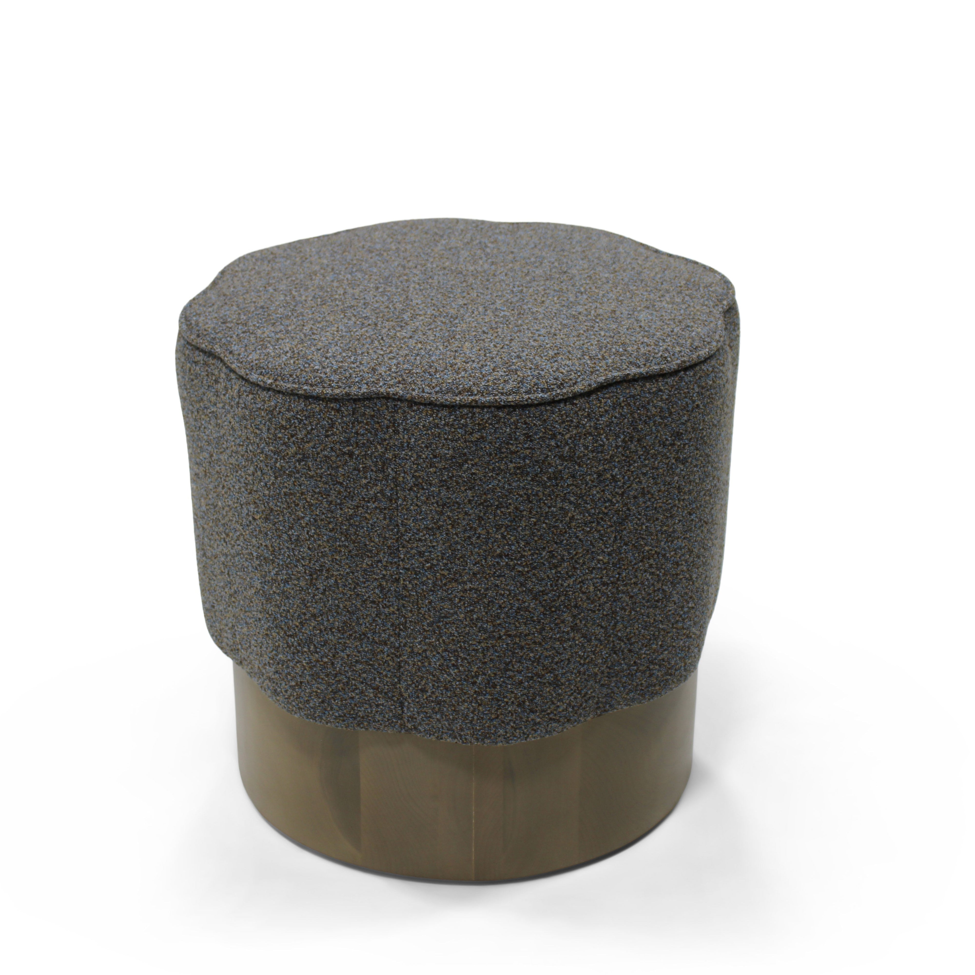 Hexagonal ottoman with textured top and wooden base on a white background